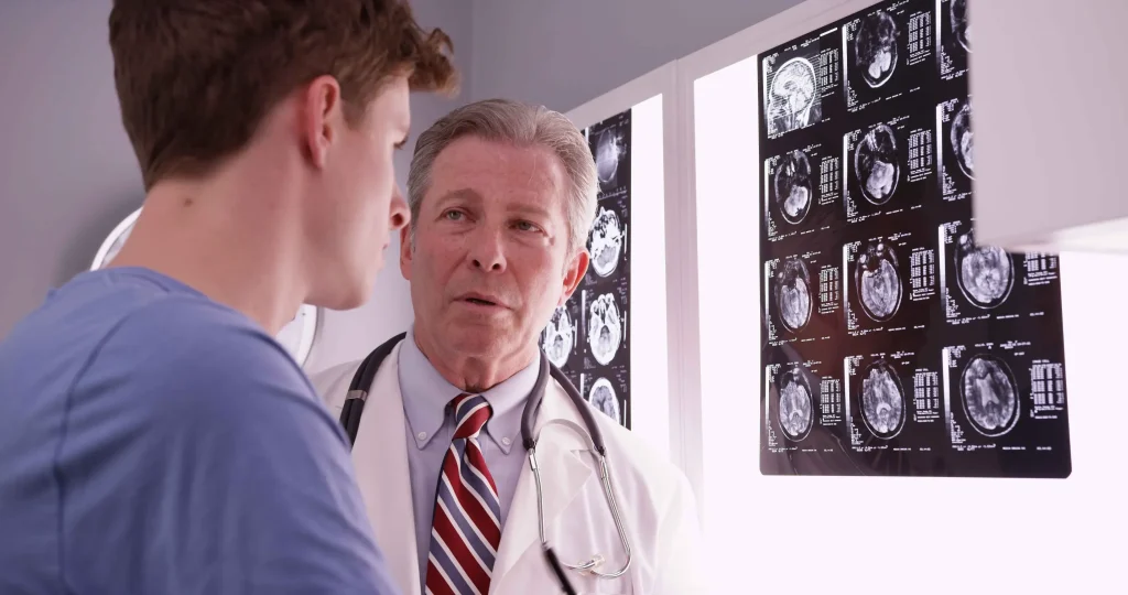 A doctor showing a patient his brain scans.