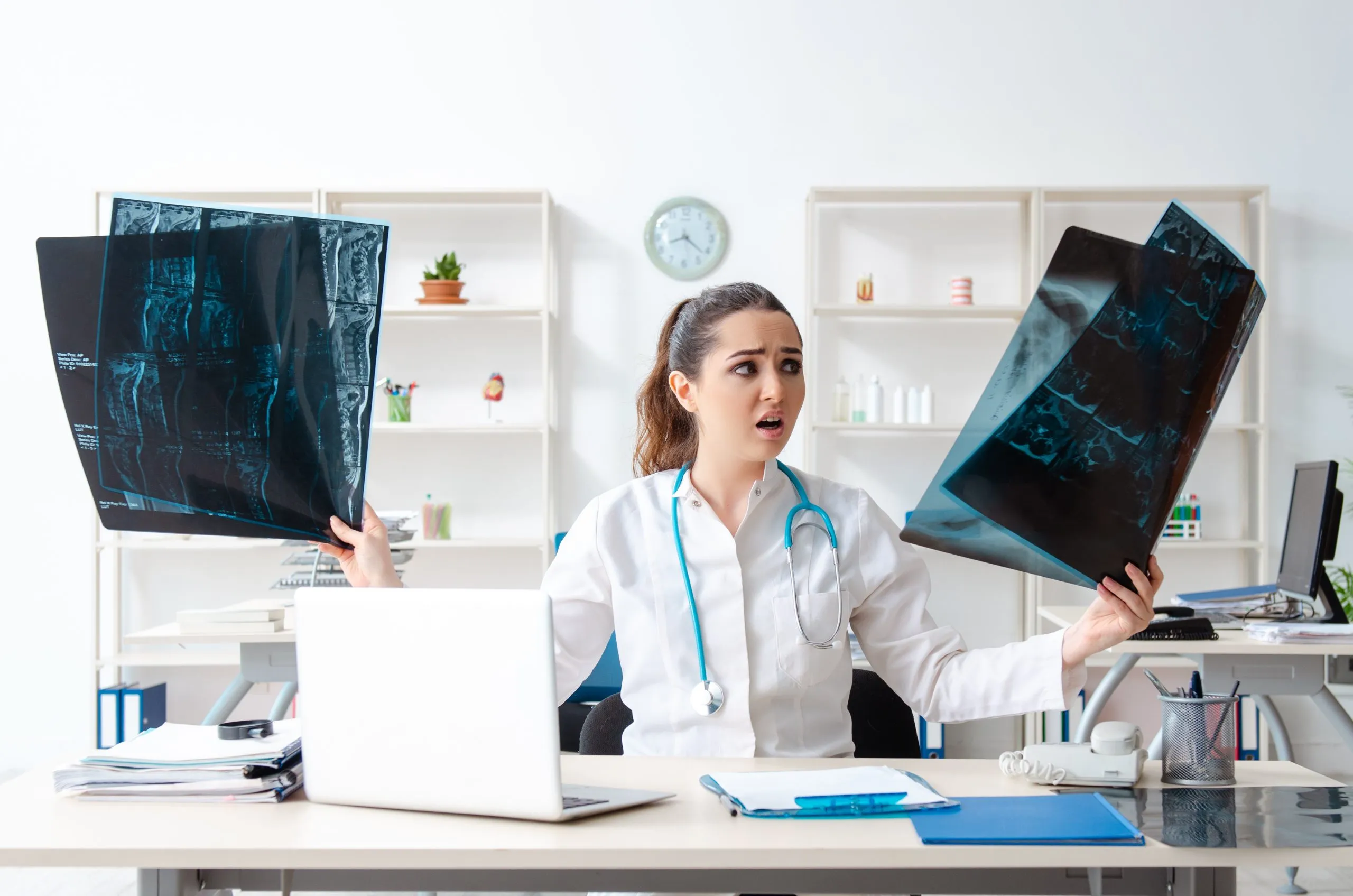 A confused doctor looking at patient records. A medical malpractice lawyer in Baltimore, Maryland can help if you’ve been injured due to medical negligence.