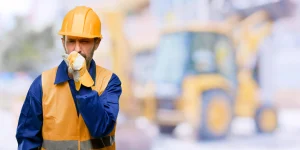 Construction worker coughing into his hand after long-term asbestos exposure. If you’ve been exposed to asbestos and your health is suffering our Baltimore mesothelioma lawyer can help you take the steps needed for compensation.