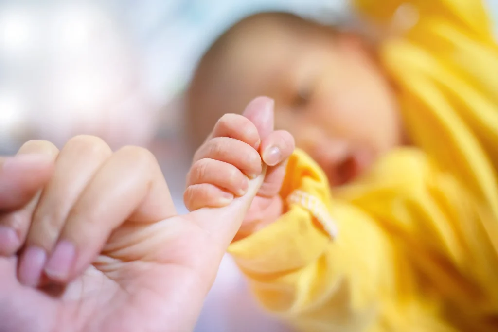 A baby wrapping his fingers around his mothers pinky. Finding out your baby suffers from Erb's Palsy can be scary. Our Baltimore Erb's Palsy lawyers can help seek compensation if the injury was preventable.