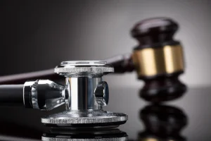 A stethescope and a gavel sitting next to each other on a table. If you or a loved one have been a victim of medical negligence, our medical malpractice lawyer in Baltimore has years of experience and is ready to fight for your justice.